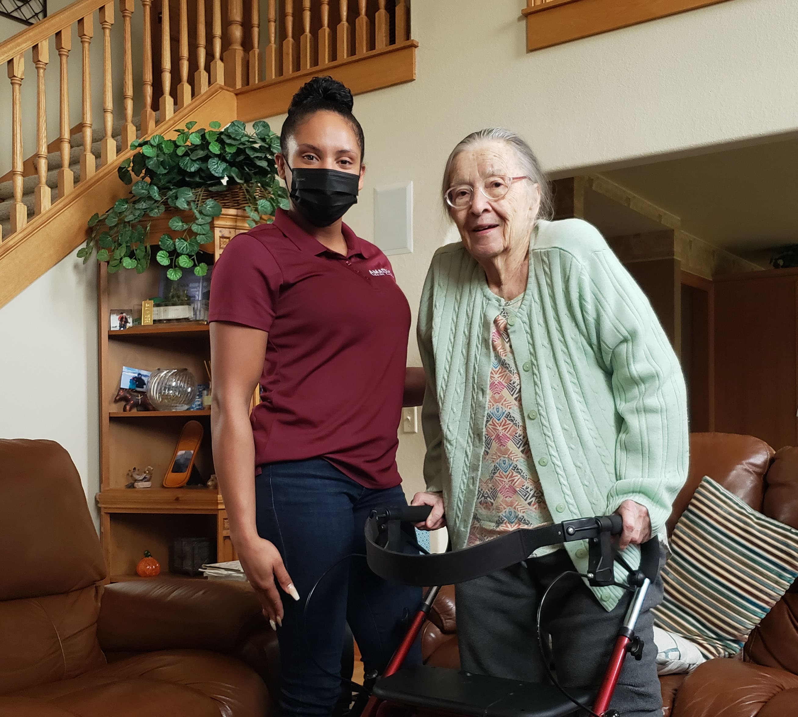 caregiver with senior and walker
