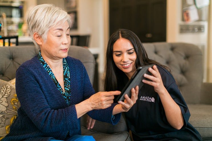 caregiver with woman and tablet