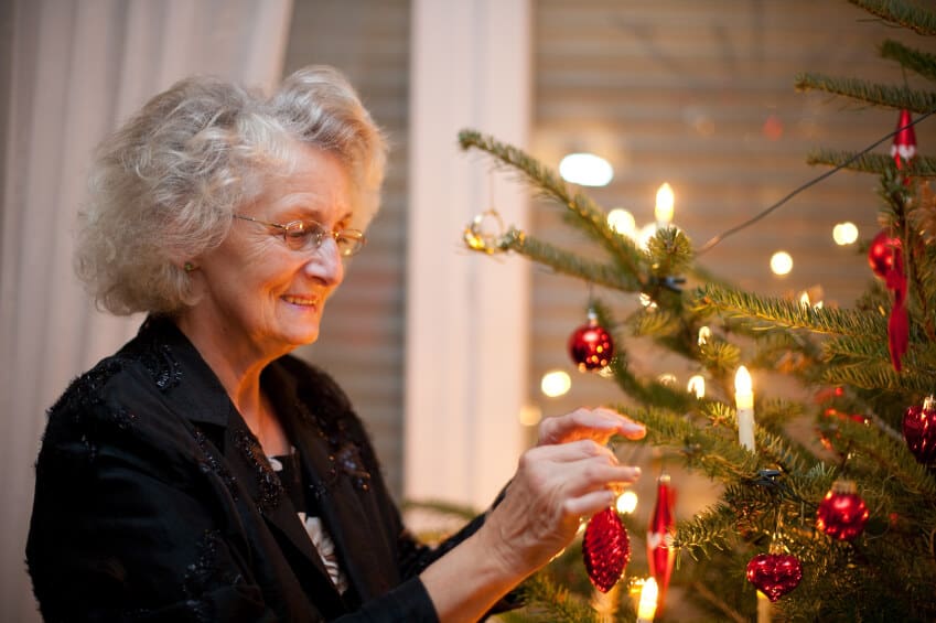 woman decorating a tree
