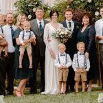 Tippets WeddingAll4.1 A post-wedding group photo of a large group of men, women, and children of various ages posing for a group photo.